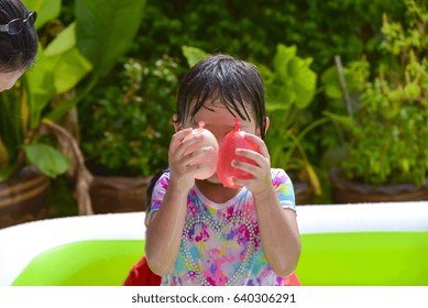 Child Playing  Water Balloons.