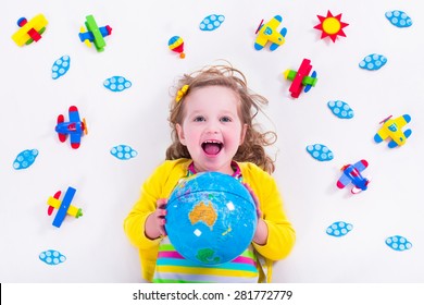 Child Playing With Wooden Airplanes. Preschooler Kid Flying Around The World. Kids Travelling And Playing. Children At Day Care Or Kindergarten. View From Above.