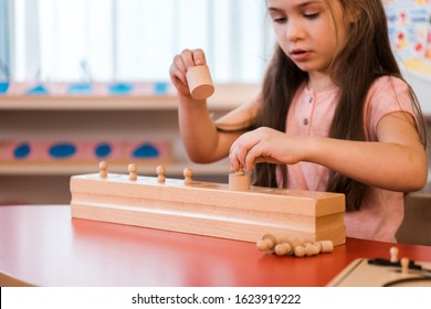 Child Playing Wooden Educational Game In Montessori School
