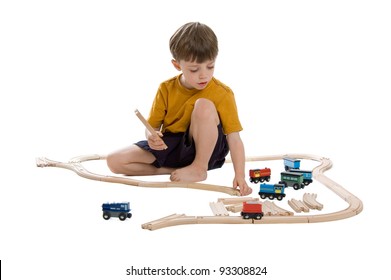 Child Playing With Wooden Train Set