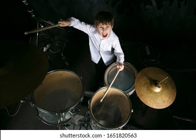 The Child Plays The Drums. Boy Musician Behind A Drum Kit.