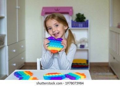 a child plays with a flapping fidget. popular children's flexible sensory toy develops fine motor skills, anti-stress, can be used for training with autistic people, popit toy