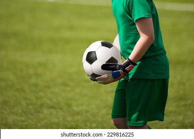 Child Plays Football Soccer Match As Goalkeeper.