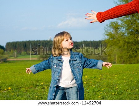 child plays on the meadow