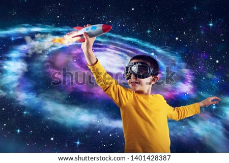 Child plays with a rocket. Concept of imagination