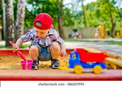 Child Plays With Sand 