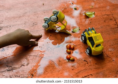 A Child Plays At The Water Table.