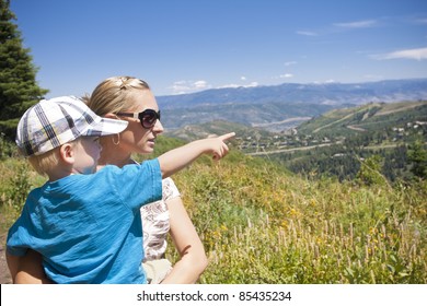 Child Pointing While On A Family Hike In The Mountains