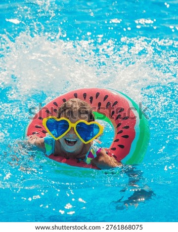 The child in the pool swims in a circle. Selective focus. Kid.