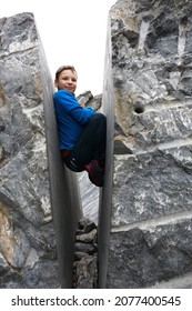 Child posing in crevice of marble of Italian quarry, Ruskeala, Karelia