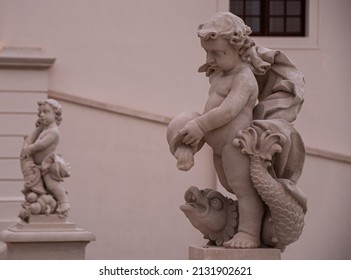 Child Pouring Into Fish Statue In Bratislava Slovakia