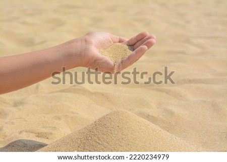 Similar – Hand im Sand Lifestyle