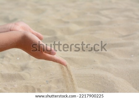 Similar – Hand im Sand Lifestyle