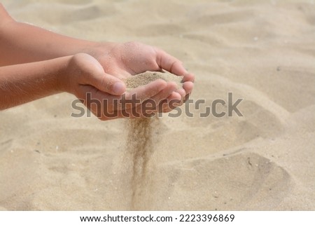 Similar – Hand im Sand Lifestyle