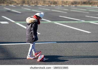 A child practicing a caster board