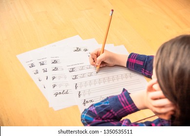 Child Practicing Cursive Writing.