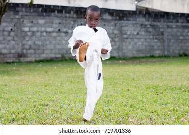 child practicing karate alone in the park - Powered by Shutterstock