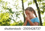 child pray. young gratitude a god religion concept. little lifestyle girl in nature outdoors praying dreams of happiness to god. praise worship freedom concept. kid praying in the forest