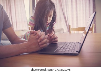 Child Praying With Father Parent With Laptop, Family And Kids Worship Online Together From Home, Streaming Online Church Service, Social Distancing, New Normal Concept