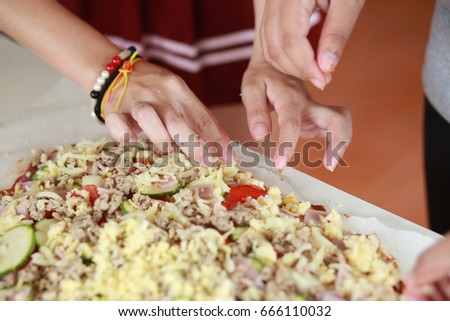 Child preparing pizza with the hands of a kid and fresh ingredien Stock photo © 