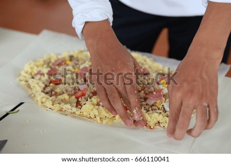Child preparing pizza with the hands of a kid and fresh ingredien Stock photo © 