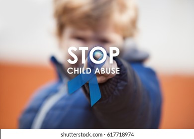 Child pressing stop child abuse awareness symbol on projection screen. Blue ribbon as sing of child abuse social issues.