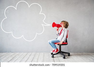 Child pretend to be businessman. Child playing at home. Kid shouting by vintage megaphone. Imagination, idea and start up concept. Speech bubble with copy space for your text - Powered by Shutterstock