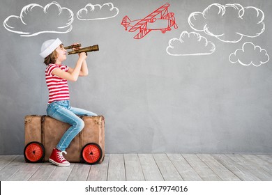 Child pretend to be pilot. Kid having fun at home. Summer vacation and travel concept