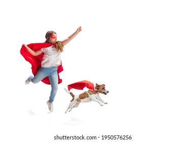 Child pretending to be a superhero with her super dog in red coats isolated on white studio background. Dreams, emotions, pet's love and friendship, motivation concept. Powerful together. Copyspace. - Powered by Shutterstock
