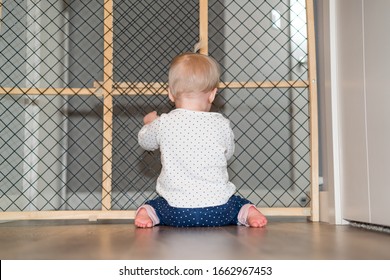 Child Proofing - Cute Baby Playing Behind Safety Gate