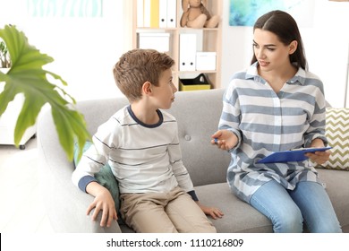 Child Psychologist Working With Boy In Office