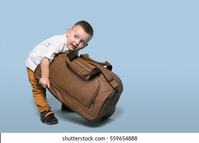 A Child Pulls a Huge Bag. Copy Space. Isolate