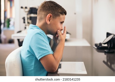 A Child Puts On A Contact Lens In An Optician.