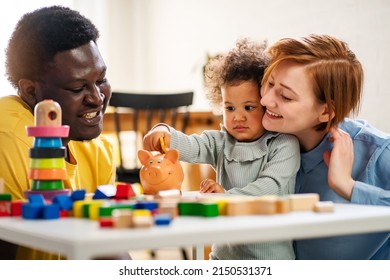 Child Is Putting A Coin Into A Piggy- Bank. Savings Bank Accounts For Kids Concept. Kid Saving Money For Future Concept.