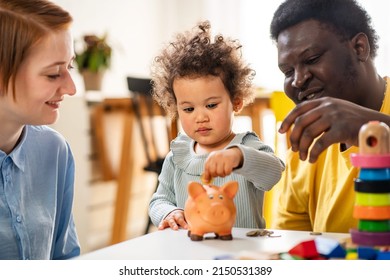 Child Is Putting A Coin Into A Piggy- Bank. Savings Bank Accounts For Kids Concept. Kid Saving Money For Future Concept.