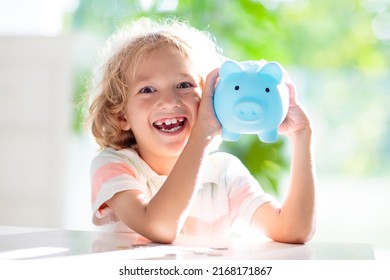 Child Putting Coin In Piggy Bank. Kids Learn About Money. Savings And Investment. Little Boy Saving Cash. Wealth Growth For Young Family With Children. Budget Planning At Home.