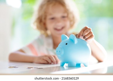 Child Putting Coin In Piggy Bank. Kids Learn About Money. Savings And Investment. Little Boy Saving Cash. Wealth Growth For Young Family With Children. Budget Planning At Home.