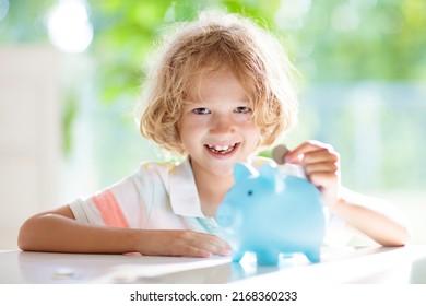 Child Putting Coin In Piggy Bank. Kids Learn About Money. Savings And Investment. Little Boy Saving Cash. Wealth Growth For Young Family With Children. Budget Planning At Home.