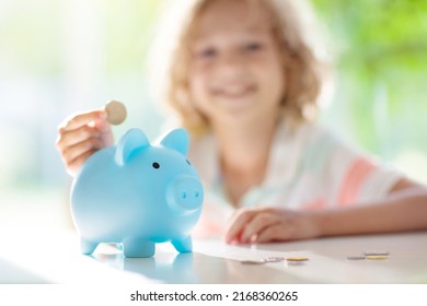 Child Putting Coin In Piggy Bank. Kids Learn About Money. Savings And Investment. Little Boy Saving Cash. Wealth Growth For Young Family With Children. Budget Planning At Home.