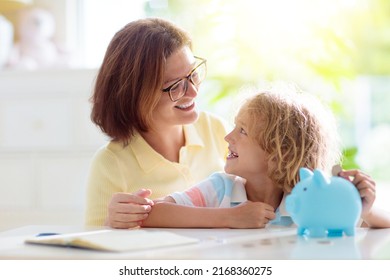 Child Putting Coin In Piggy Bank. Kids Learn About Money. Savings And Investment. Little Boy Saving Cash. Wealth Growth For Young Family With Children. Budget Planning At Home.