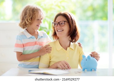 Child Putting Coin In Piggy Bank. Kids Learn About Money. Savings And Investment. Little Boy Saving Cash. Wealth Growth For Young Family With Children. Budget Planning At Home.