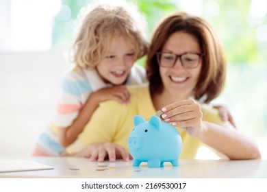 Child Putting Coin In Piggy Bank. Kids Learn About Money. Savings And Investment. Little Boy Saving Cash. Wealth Growth For Young Family With Children. Budget Planning At Home.