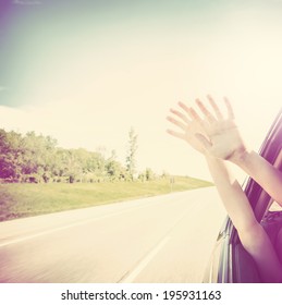 Child Putting Their Hands Out Of The Car Window 