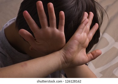 Child raising hands to protect itself - Shutterstock ID 126128162