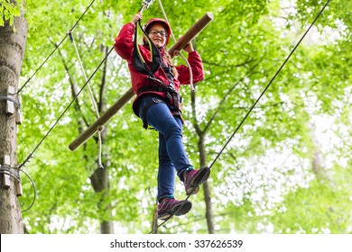 Child Reaching Platform Climbing In High Rope Course