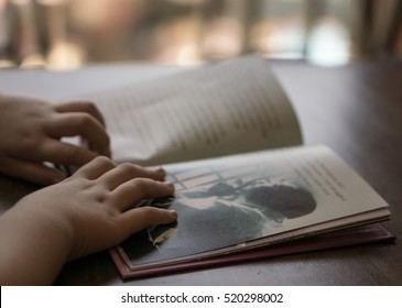 Child Reading The Book