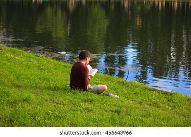 A child reads a book on the nature - Shutterstock ID 456643966
