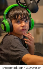 Child Ready And Equipped To Start Gaming And Live Streaming At Home In His Room.