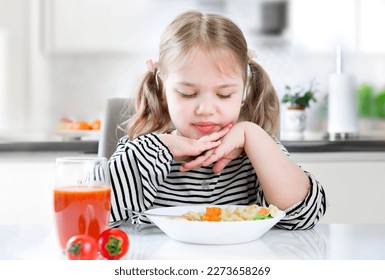 Child refuses to eat,not hungry kid,doesn't like food.No appetite.Unhappy expression. Little girl does not want to eat. - Shutterstock ID 2273658269