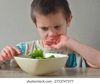 Child refusing vegetables - Picky eater child with bowl of broccoli